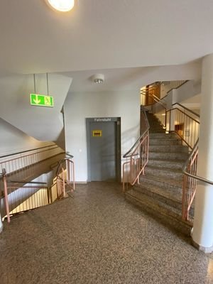 Treppenaufgang mit zentralem Fahrstuhl